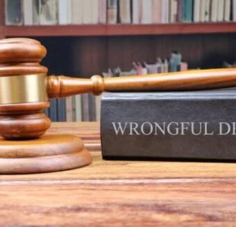 A gavel resting beside a book titled 'Wrongful Death,' symbolizing legal proceedings in a wrongful death case